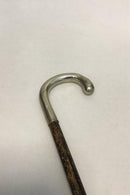 Antique German walking stick with a head of silver, stamped silber. Shaft of black painted wood. Modern ferule of black rubber.