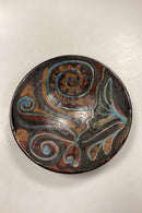 Stentøjsskål i brune, gule og blå nuancer