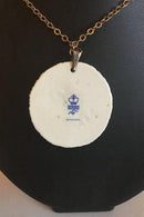 Royal Copenhagen Pendant of porcelain with gold decoration. Designed by Nils Thorson. Sterling Silver by Anton Michelsen