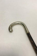 Antique German walking stick with a head of silver, stamped silber. Shaft of black painted wood. Modern ferule of black rubber.
