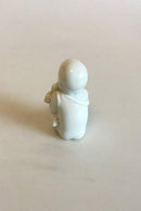 Royal Copenhagen Blanc de Chine Figurine of Baby with flowers
