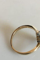 Guldring i 14 K med 16 små sten