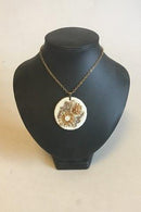 Royal Copenhagen Pendant of porcelain with gold decoration. Designed by Nils Thorson. Sterling Silver by Anton Michelsen
