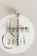 Pendant in 18 K. White gold shaped like cross with 16 red stones