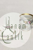 Bing & Grøndahl kop og underkop i guld og polykrom overglasur med blomstermotiv.