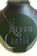 Chain in 14K. White gold with round pendant with 30 small stones