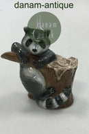 Royal Copenhagen Figurine of Raccoon on tree stump No 054