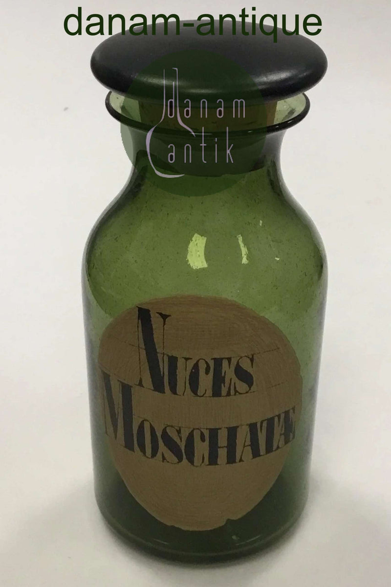 Holmegaard Apotekerflasken, krukke med tekst Nuces Moschatæ fra 1985