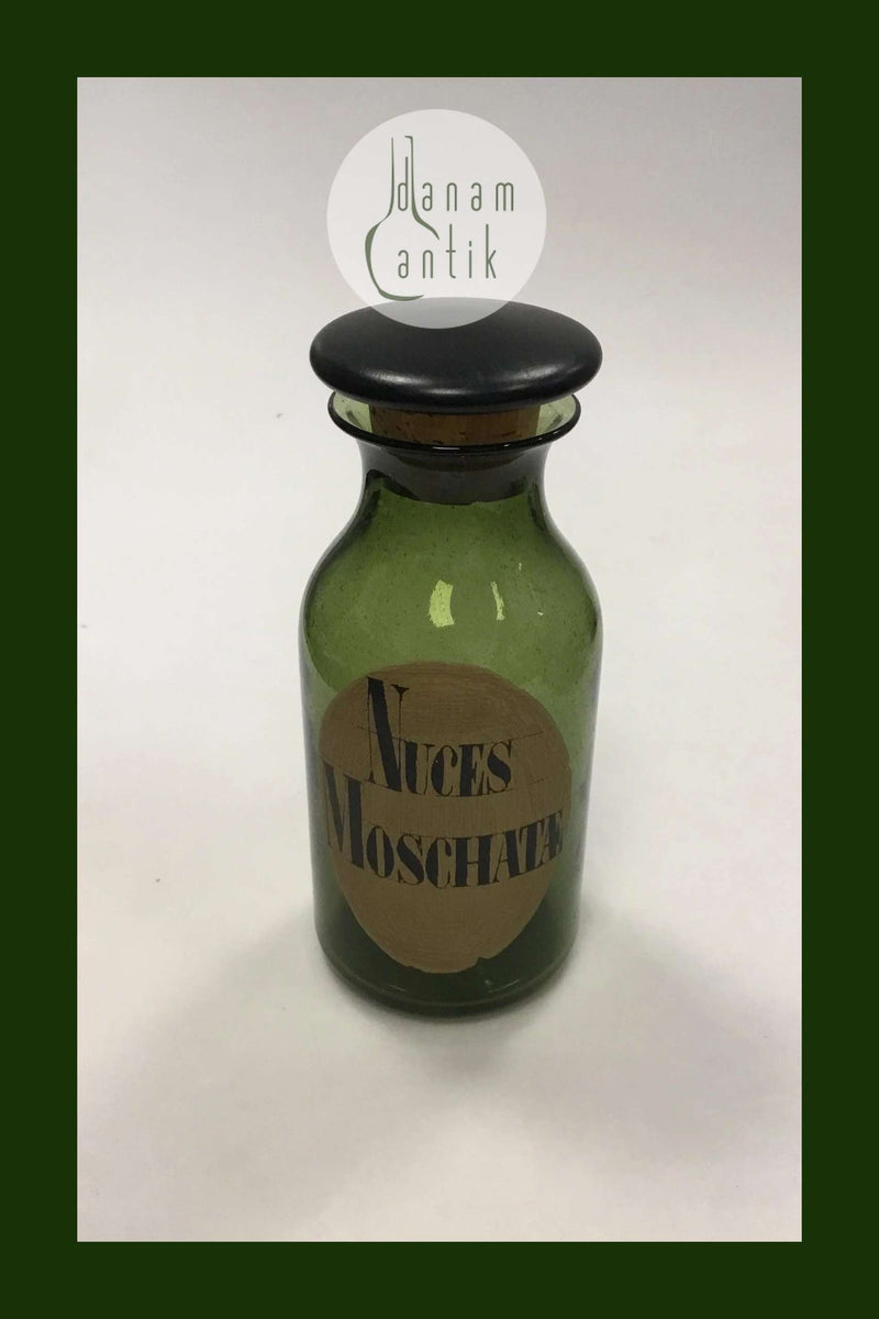 Holmegaard Apotekerflasken, krukke med tekst Nuces Moschatæ fra 1985