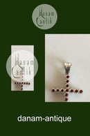 Pendant in 18 K. White gold shaped like cross with 16 red stones