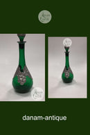 Grüne Weinflasche mit Zinndekoration