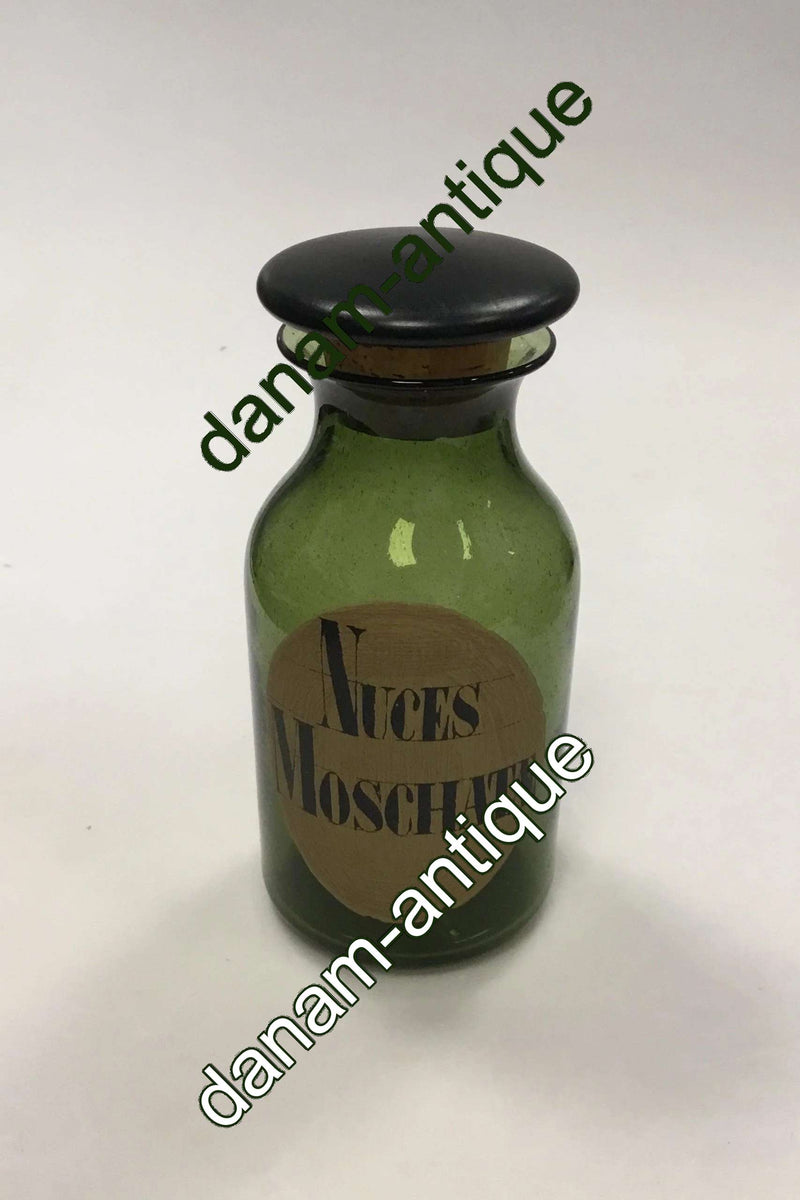 Holmegaard Apotekerflasken, krukke med tekst Nuces Moschatæ fra 1985