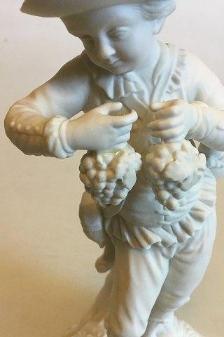Royal Copenhagen Bisquitfigur af dreng med drueklaser - Danam Antik